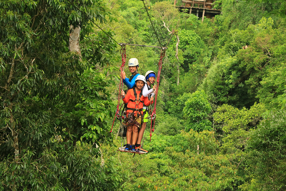 Oliver (in white) ziplines on a board high above a jungle in Mexico with his cousins, Reagan and Robbie. August, 2021